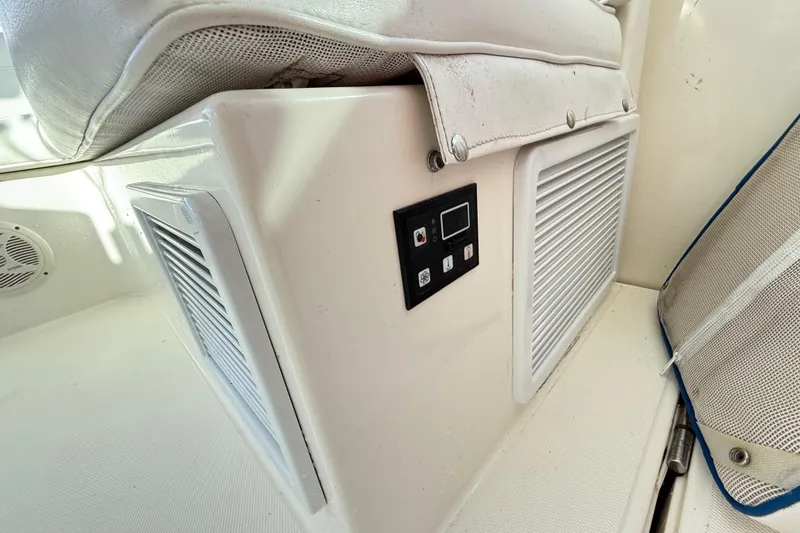 Slide: The Image of Helm view of a 1996 Cabo 35 yacht docked in a serene marina. - 21