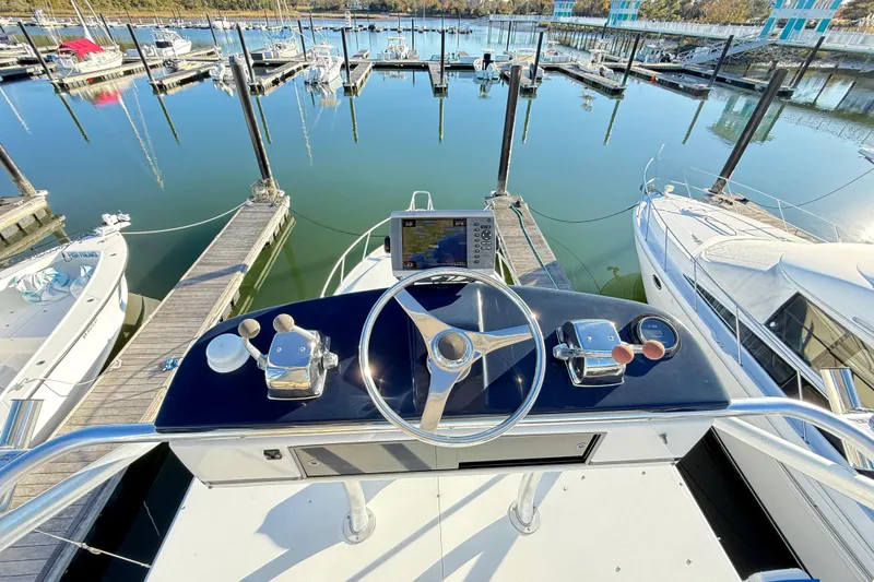 Slide: The Image of 1996 Cabo 35 boat with Garmin navigation, docked at a marina. - 23