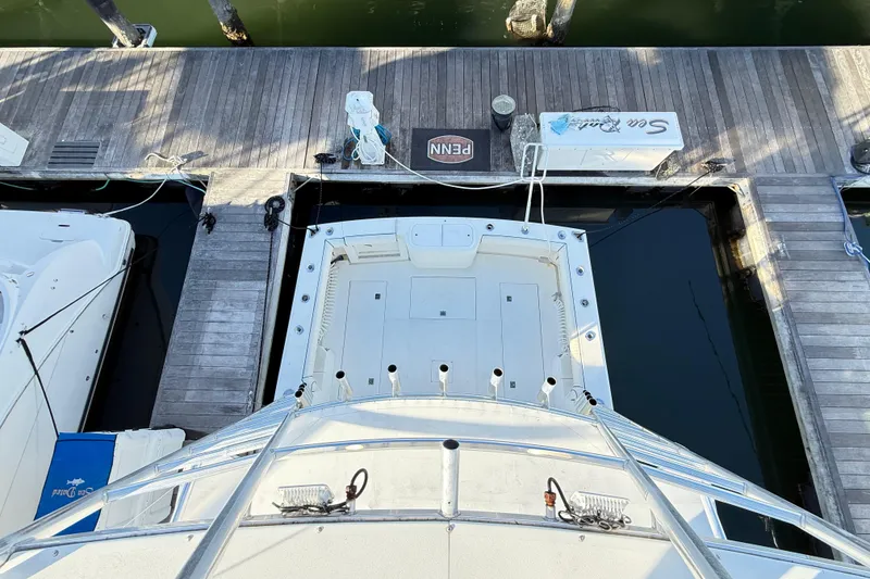 Slide: The Image of 1996 Cabo 35 boat canopy with marina view under clear blue sky. - 27