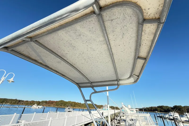 Slide: The Image of Open storage compartment on a 1996 Cabo 35 boat, dockside view. - 28