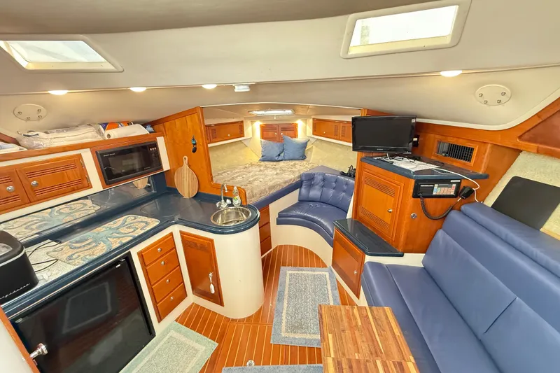 Slide: The Image of Interior of a 1996 Cabo 35 yacht with kitchen and seating area. - 33
