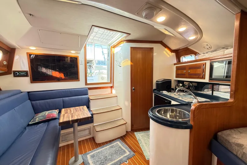 Slide: The Image of Interior of a 1996 Cabo 35 yacht with bed and seating area. - 34