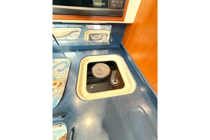 Slide: The Image of Interior compartment of a 1996 Cabo 35 boat, showing wiring and wear. - 45