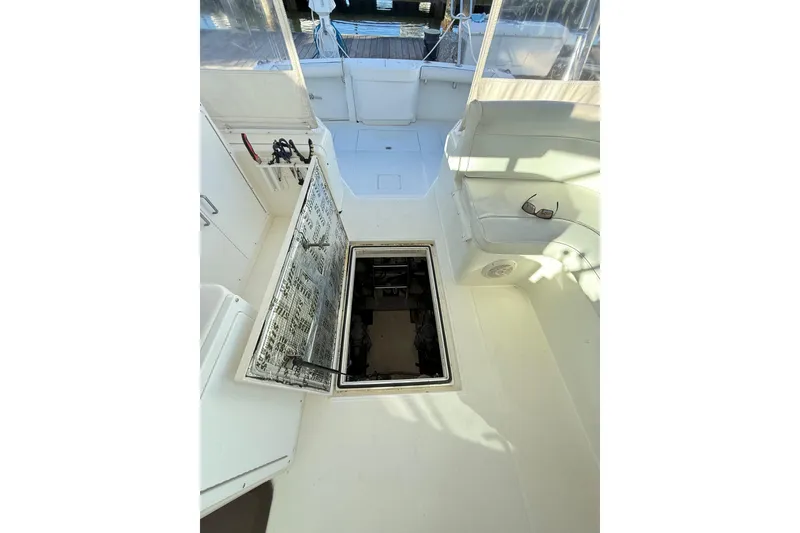 Slide: The Image of Storage compartment on a 1996 Cabo 35 boat with cleaning supplies and equipment. - 50