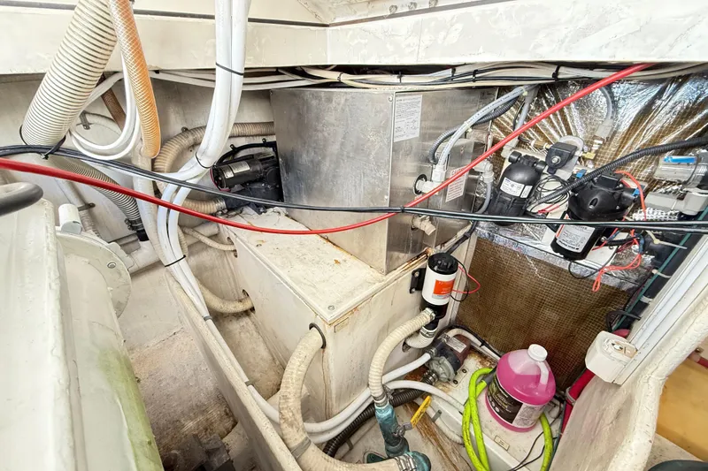 Slide: The Image of Electrical system inside a 1996 Cabo 35 boat, featuring a 50 AMP battery charger. - 53
