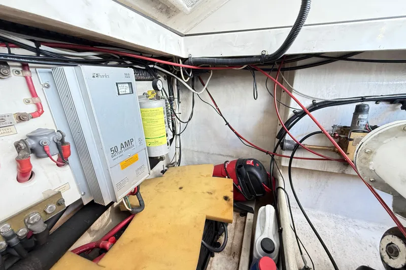 Slide: The Image of Engine compartment of a 1996 Cabo 35 boat, showing various mechanical components and hoses. - 54