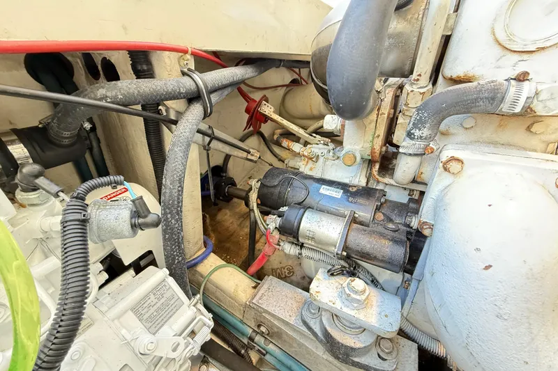 Slide: The Image of Engine compartment of a 1996 Cabo 35 boat, featuring various mechanical components and wiring. - 55
