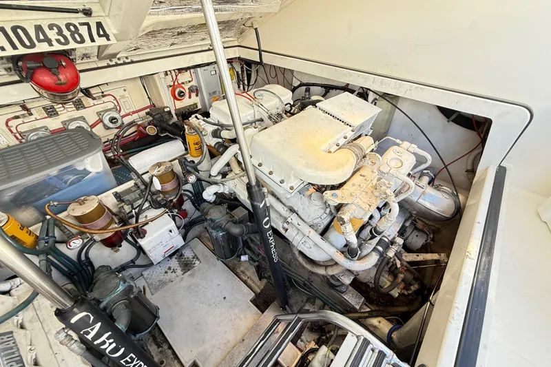 Slide: The Image of Engine room of a 1996 Cabo 35 boat, showcasing mechanical components and systems. - 59