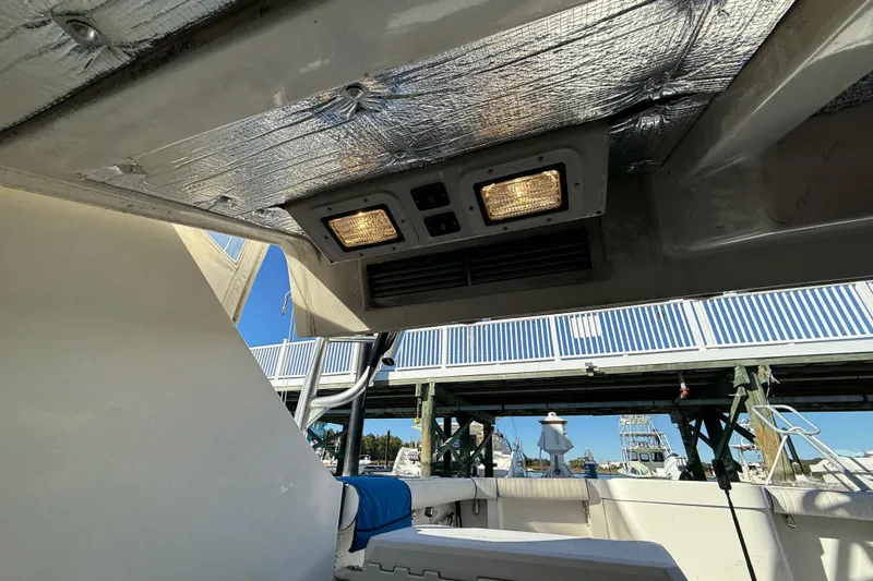 Slide: The Image of Interior view of a 1996 Cabo 35 boat with overhead lighting and insulation. - 62