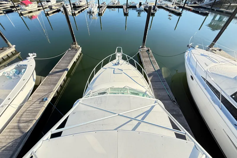 Slide: The Image of 1996 Cabo 35 boat with tower ladder, docked at marina under clear blue sky. - 65