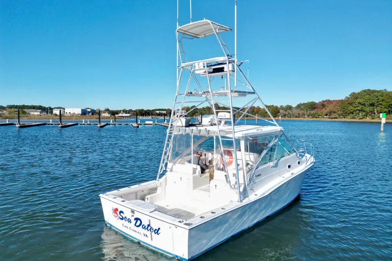Slide: The Image of 1996 Cabo 35 boat on calm water with clear blue sky. - 7