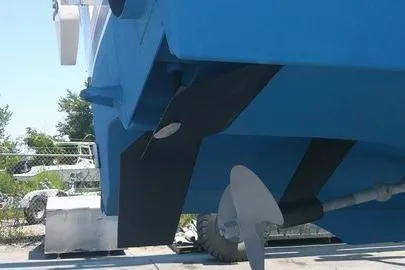 Slide: The Image of 1996 Cabo 35 boat propeller and hull underside in dry dock. - 76