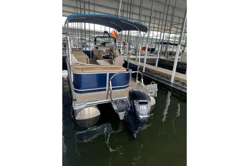 Slide: The Image of 2019 Harris CX 230 pontoon boat docked with Mercury 115 outboard motor. - 10