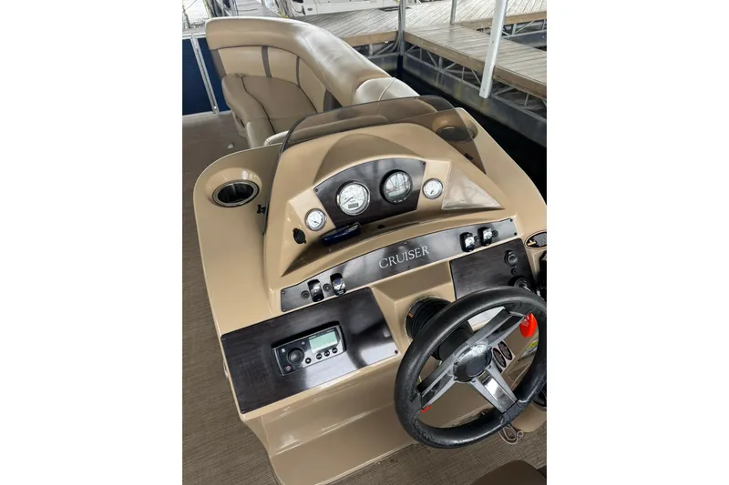 Slide: The Image of 2019 Harris CX 230 boat dashboard with steering wheel and controls. - 8