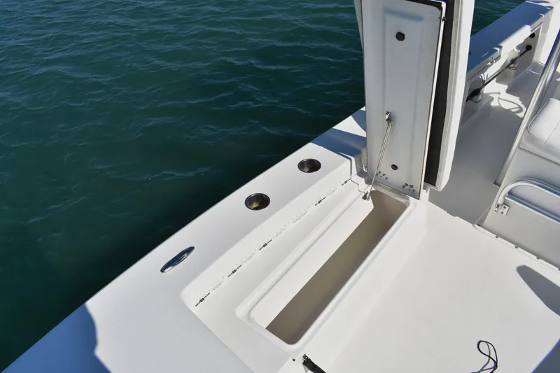 Slide: The Image of 2017 Bay Rider 2260 FS Skiff boat deck with storage compartment and cup holders. - 7