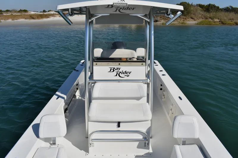 Slide: The Image of 2017 Bay Rider 2260 FS Skiff on calm water near sandy shore. - 8