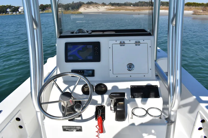 Slide: The Image of 2017 Bay Rider 2260 FS Skiff dashboard with steering wheel and navigation system. - 9