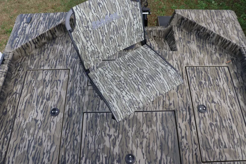Slide: The Image of Camouflage-patterned deck of 2026 Sea Ark Phantom 20XV CC boat with folding seat. - 6