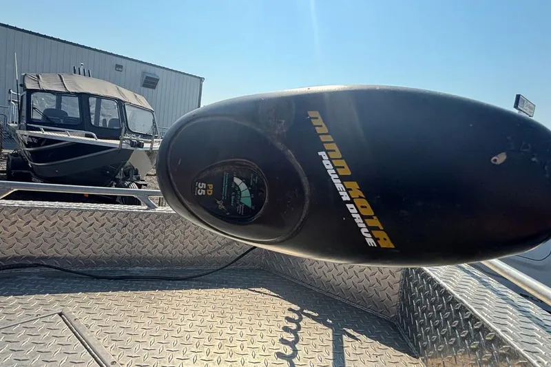 Slide: The Image of Minn Kota Power Drive motor on 2005 THINDERJET 21 ALEXIS boat, with trailer in background. - 3