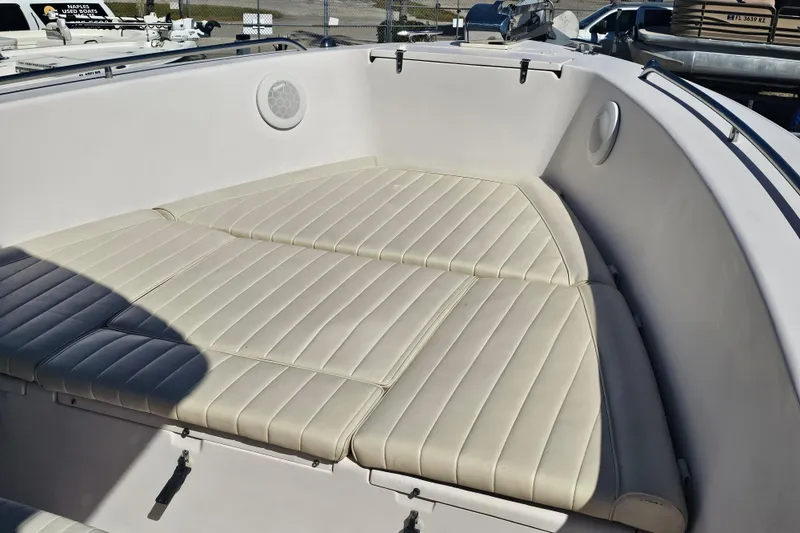 Slide: The Image of 2003 Grady-White Bimini 306 boat interior with cushioned seating area. - 12