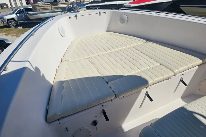 Slide: The Image of 2003 Grady-White Bimini 306 boat interior with cushioned seating and storage compartments. - 13