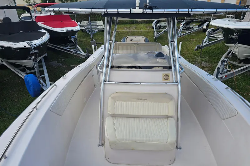 Slide: The Image of 2003 Grady-White Bimini 306 boat with seating and canopy, docked among other boats. - 20