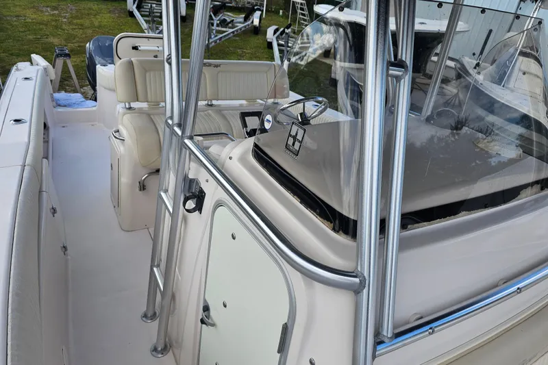 Slide: The Image of 2003 Grady-White Bimini 306 boat interior with seating and steering console. - 21