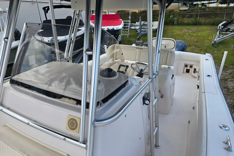 Slide: The Image of 2003 Grady-White Bimini 306 boat interior with steering console and seating. - 22