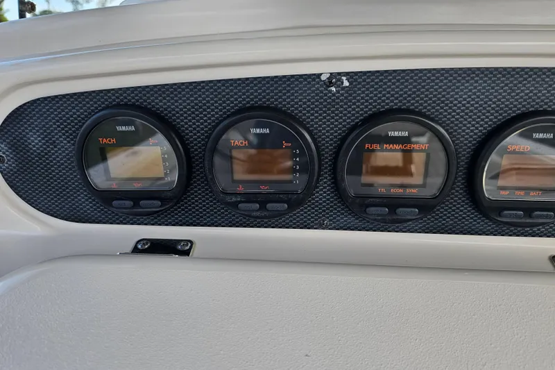 Slide: The Image of Yamaha gauges on 2003 Grady-White Bimini 306 boat dashboard. - 26