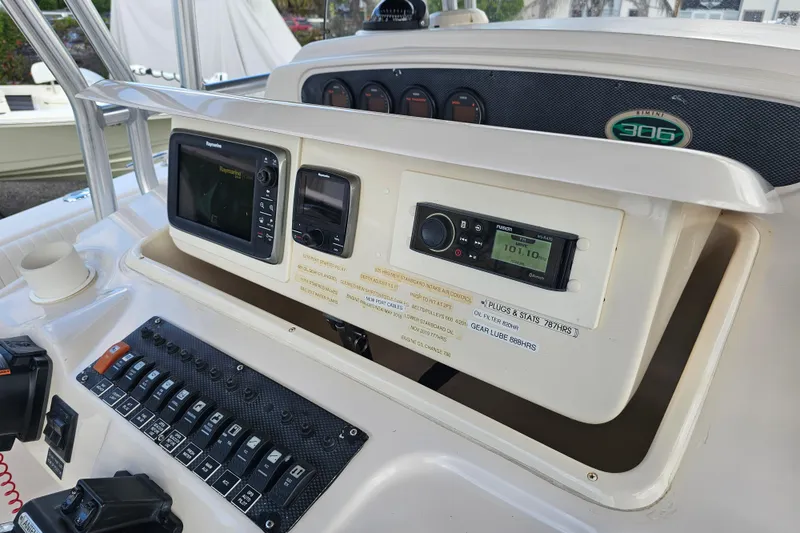 Slide: The Image of 2003 Grady-White Bimini 306 boat dashboard with navigation and control systems. - 30