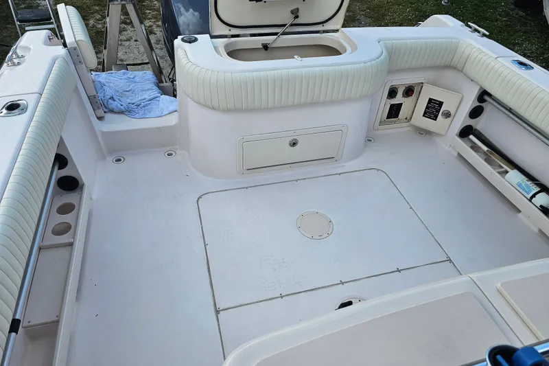 Slide: The Image of 2003 Grady-White Bimini 306 boat interior with seating and storage compartments. - 34