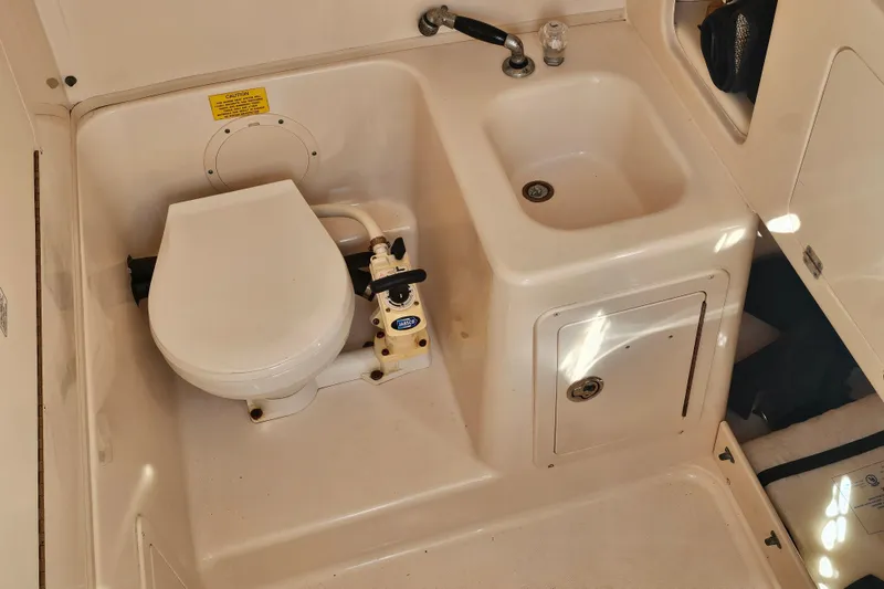 Slide: The Image of 2003 Grady-White Bimini 306 boat bathroom with toilet and sink. - 37
