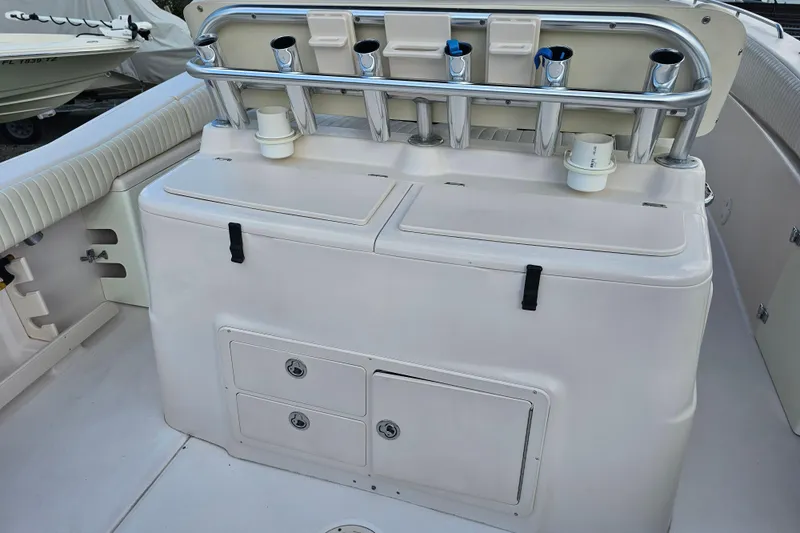 Slide: The Image of 2003 Grady-White Bimini 306 boat interior with rod holders and storage compartments. - 41