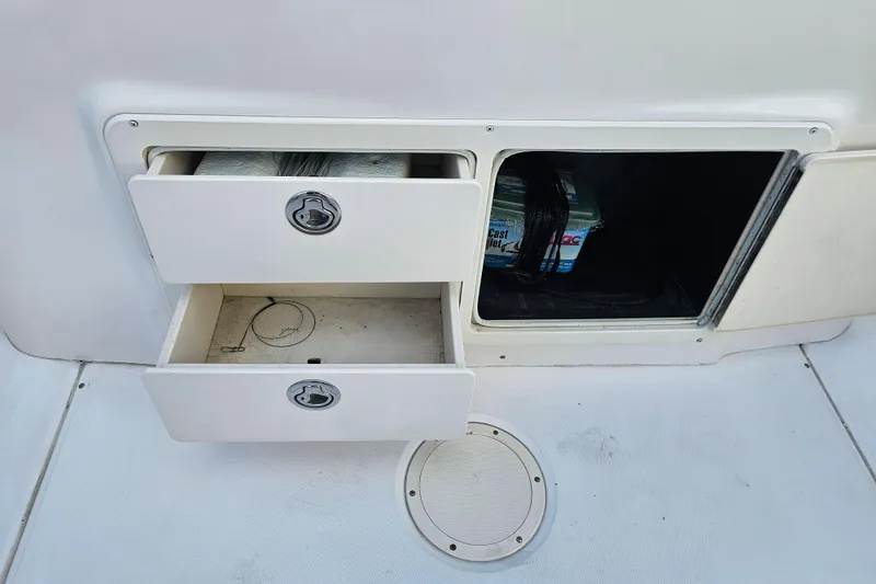 Slide: The Image of 2003 Grady-White Bimini 306 boat storage compartments with open drawers and hatch. - 42