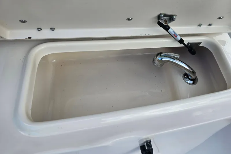 Slide: The Image of 2003 Grady-White Bimini 306 boat sink with chrome faucet. - 44