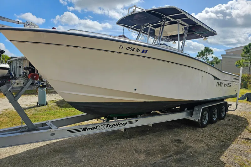 Slide: The Image of 2003 Grady-White Bimini 306 boat on trailer under blue sky. - 7