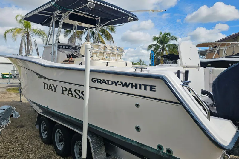 Slide: The Image of 2003 Grady-White Bimini 306 boat on trailer, palm trees in background. - 9
