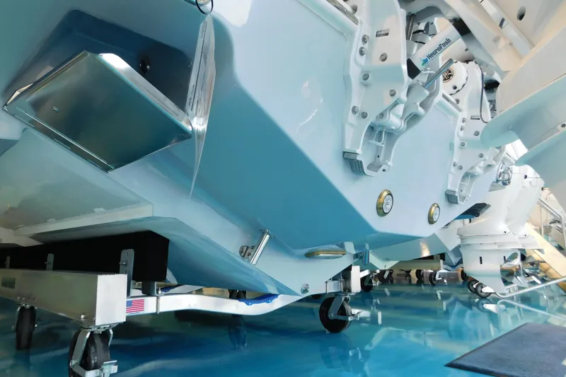 Slide: The Image of 2025 Solace 32 CS boat hull and components on display in a showroom. - 3
