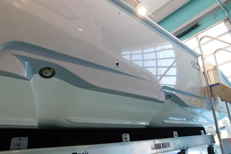 Slide: The Image of 2025 Solace 32 CS boat displayed indoors, showcasing sleek hull design. - 4