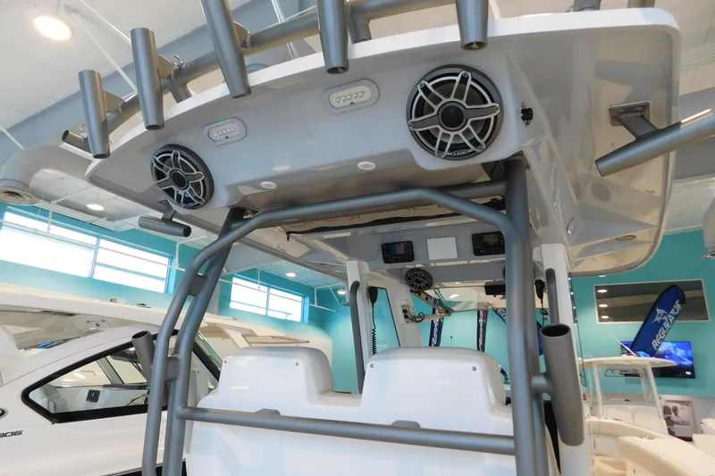 Slide: The Image of 2025 Solace 32 CS boat interior with speakers and rod holders in showroom. - 7
