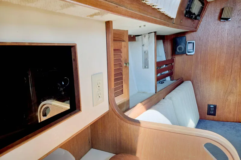 Slide: The Image of Interior of 1985 S2 Yachts 9.2 C sailboat with wood paneling and seating area. - 10