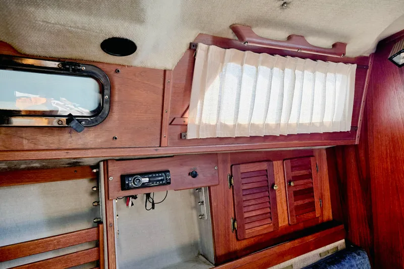 Slide: The Image of Interior of 1985 S2 Yachts 9.2 C sailboat with wood paneling and window. - 11