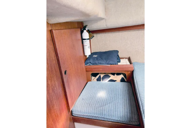 Slide: The Image of Interior of 1985 S2 Yachts 9.2 C with wooden paneling and blue cushions. - 12