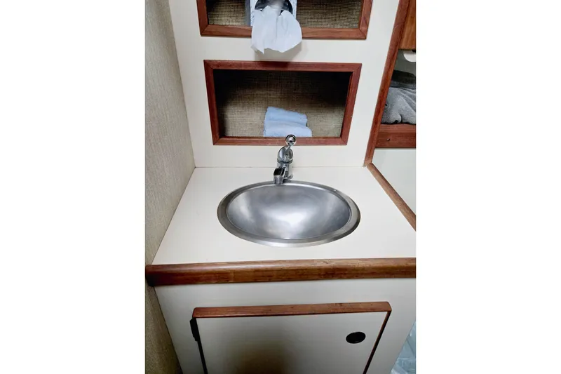 Slide: The Image of Compact sink area in 1985 S2 Yachts 9.2 C sailboat with wooden trim. - 18