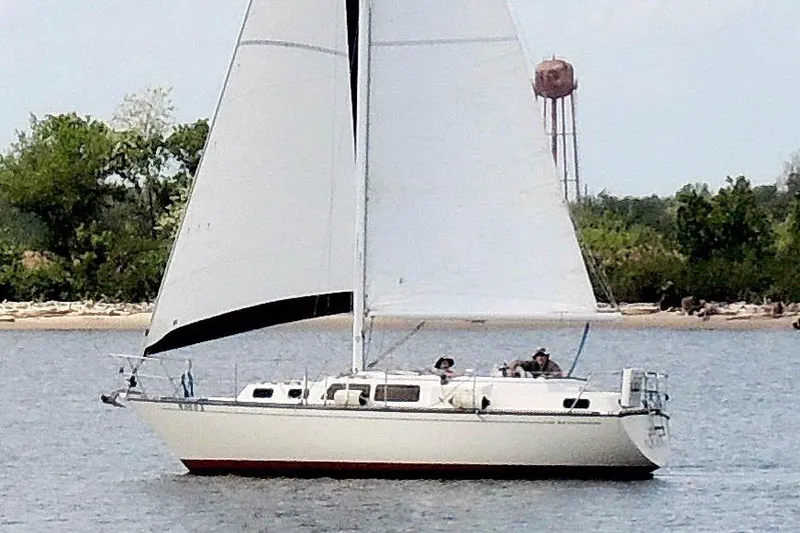 Slide: The Image of 1985 S2 Yachts 9.2 C sailboat cruising on a calm lake near shoreline. - 2