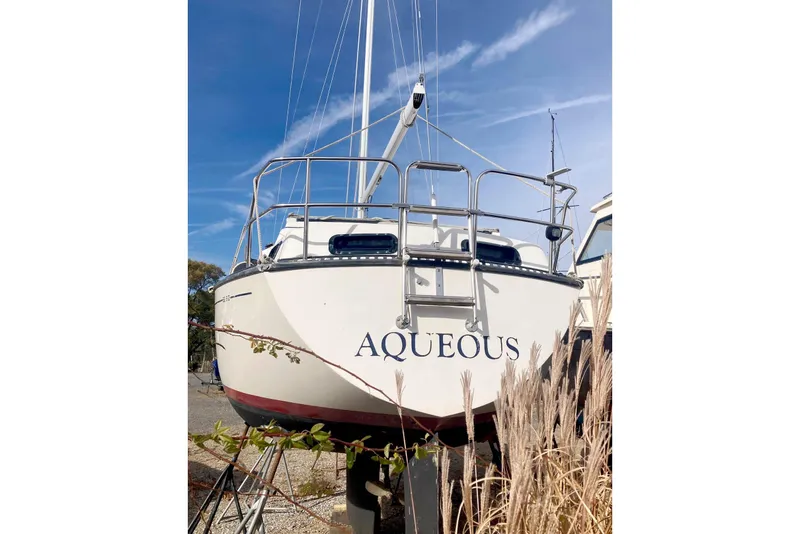 Slide: The Image of 1985 S2 Yachts 9.2 C sailboat named "Aqueous" on land, clear sky background. - 6