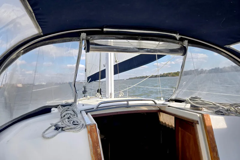 Slide: The Image of 1985 S2 Yachts 9.2 C sailboat cockpit view with clear skies and water. - 7
