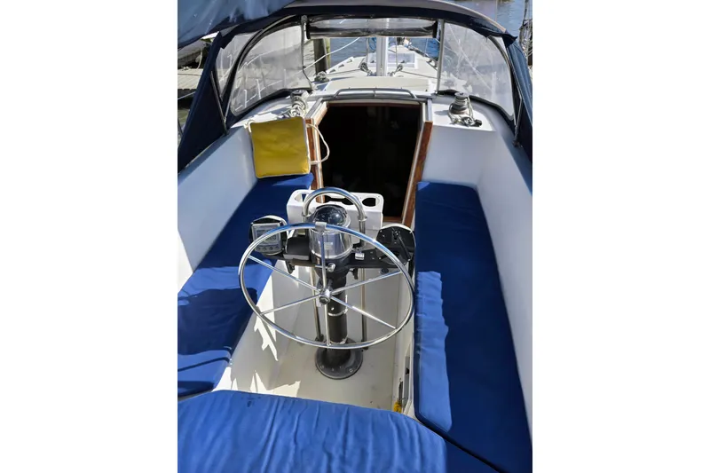 Slide: The Image of 1985 S2 Yachts 9.2 C sailboat cockpit with blue seating and steering wheel. - 8