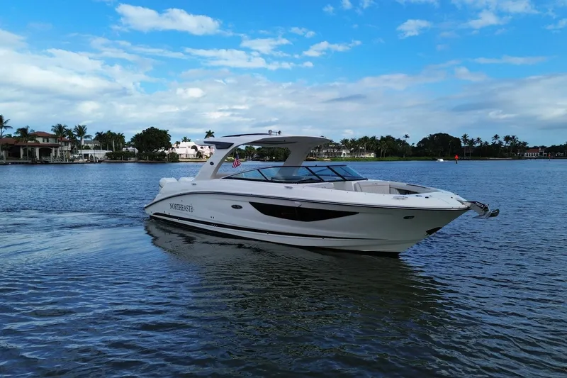 Slide: The Image of 2022 Sea Ray SLX 350 Outboard boat cruising on a scenic waterway. - 1