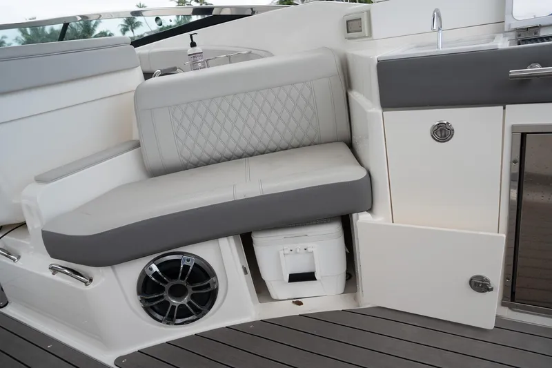 Slide: The Image of 2022 Sea Ray SLX 350 Outboard interior with seating, speaker, and storage compartments. - 14